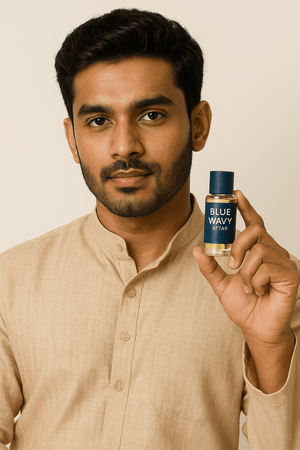 Man holding Blue Wavy attar perfume bottle in traditional attire showcasing its design.