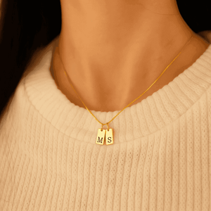 Custom initial letter necklace in gold featuring 'M' and 'S' charm for personalized style