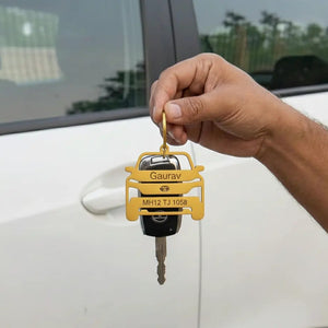 Customized car-shaped keychain with engraved name and vehicle number.