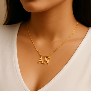 Gold dual letter necklace “AN” worn by a woman – personalized initial pendant jewelry