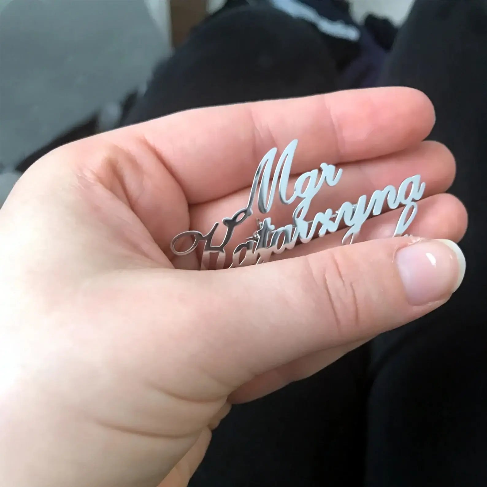 “Personalized silver name brooch held in hand – custom name jewelry for men and women