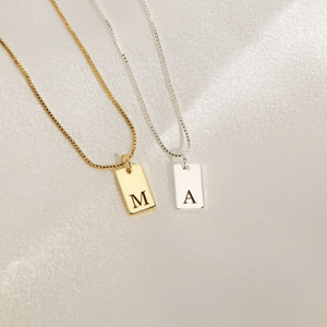 Custom initial letter necklace in gold and silver with engraved letters for personalized style