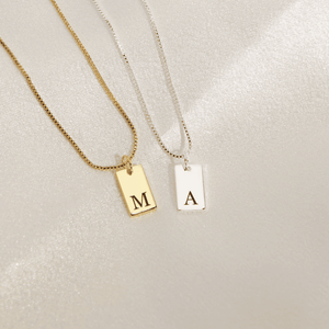 Custom initial letter necklace in gold and silver with engraved letters for personalized style