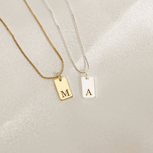 Custom initial letter necklace in gold and silver with engraved letters for personalized style