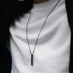 Ankx.in black metal Bar Name Necklace worn on a white shirt with a simple chain design