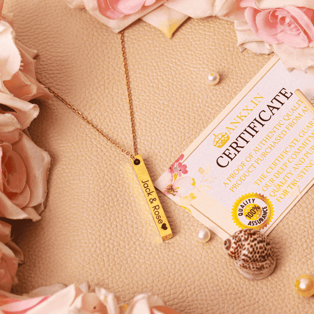 Ankx.in Bar Name Necklace with gold bar pendant engraved with Jack & Rose surrounded by roses and a certificate