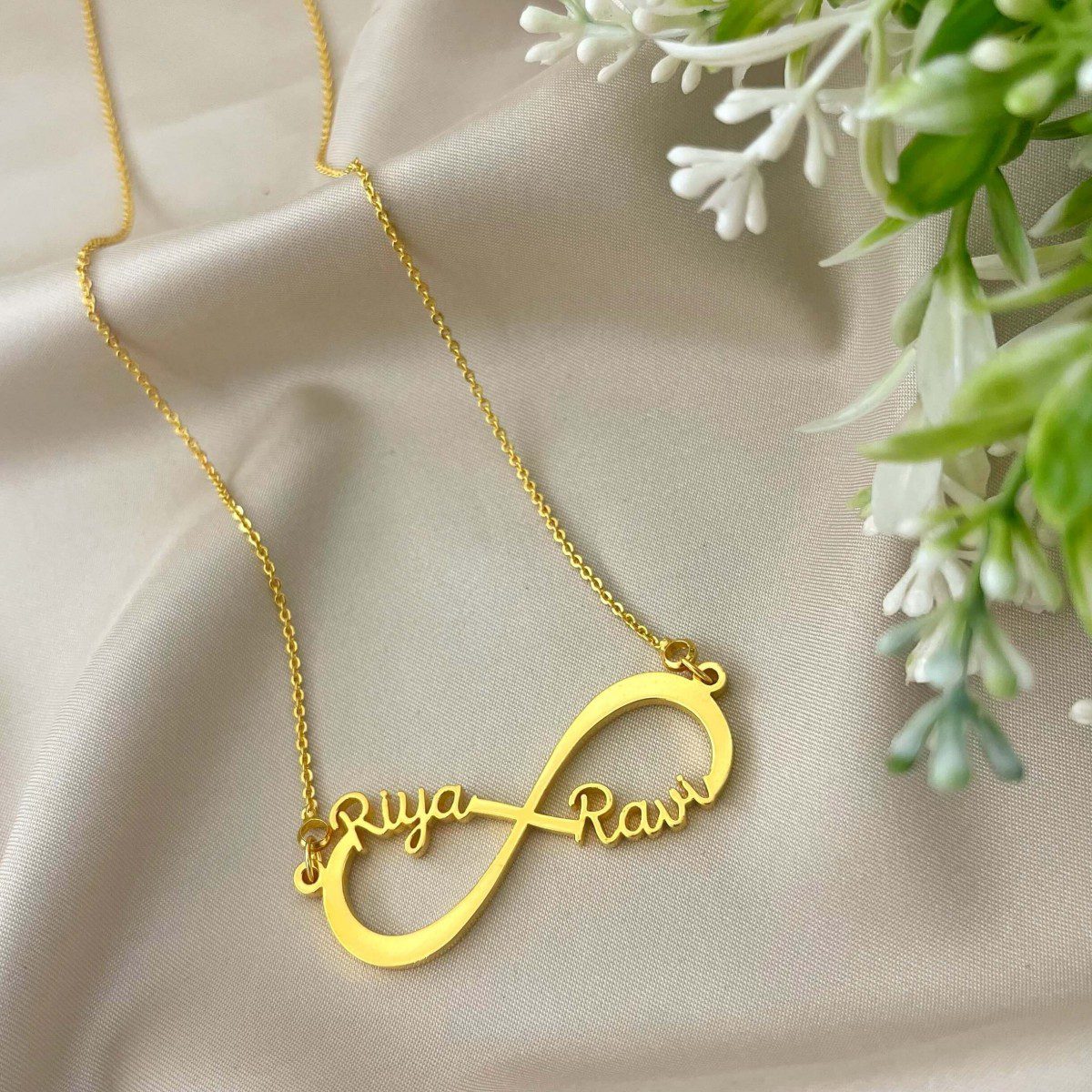 Gold tone Couple Custom Name Necklace Pendant with infinity design on satin background
