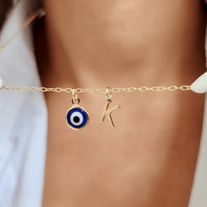 Ankx.in Evil Eye Pendant Necklace featuring a blue eye charm and a gold letter K charm