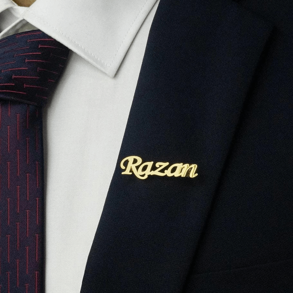 Personalized name lapel pin in gold, worn on a suit jacket for a stylish touch