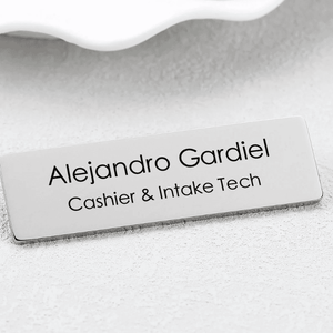 Personalized engraved metal name brooch with sleek silver finish for professional use
