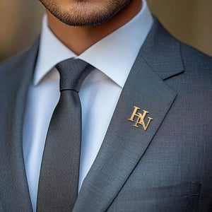 Custom Initials Brooch in gold displayed on a tailored suit lapel for elegant style.