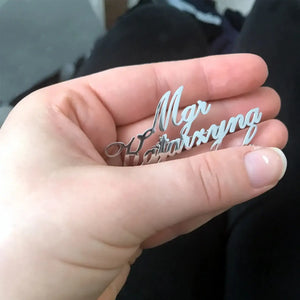 custom name brooch for men held in hand showing a detailed name design