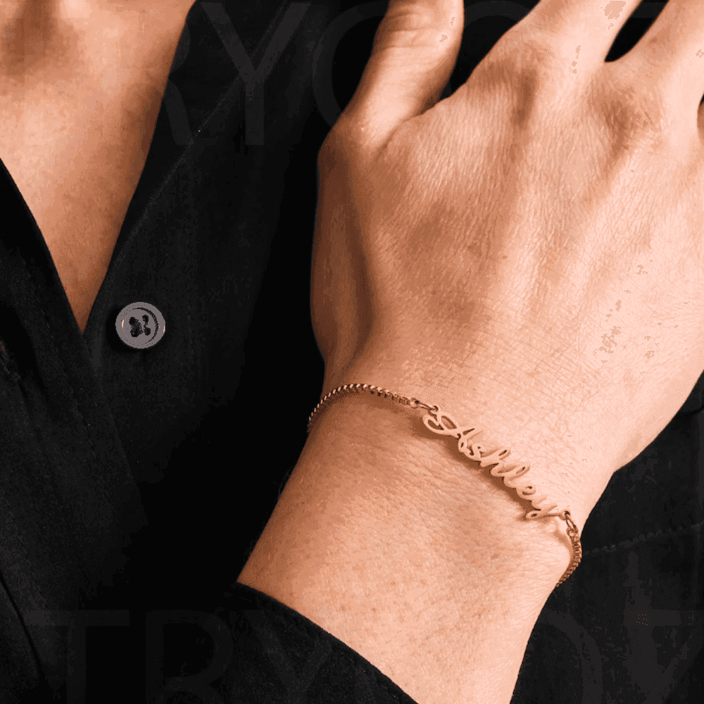 Gold custom name chain bracelet worn on wrist, perfect for personalized gifts and fashion accessories