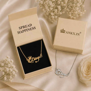 Custom name necklace with crown in a gold finish inside an ANKX gift box, alongside a matching silver personalized necklace featuring the name Divya.