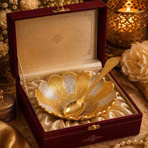 Ornate gold bowl and spoon set in an open velvet gift box