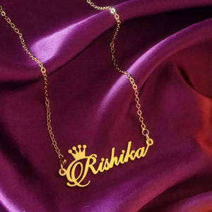 Gold Name Necklace With Crown featuring the name Rishika on a luxurious backdrop