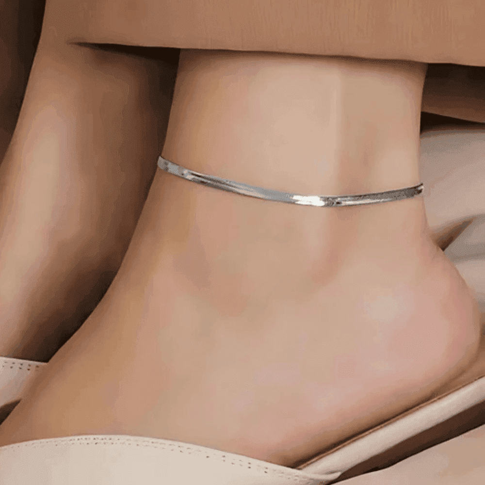 Minimal silver anklet for women showcased elegantly on a bare ankle