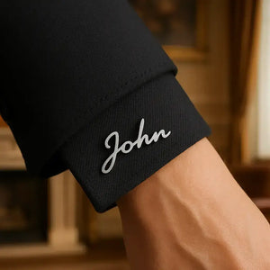 Name cuff brooch worn on black shirt sleeve for men