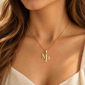 Woman wearing a gold M P personalized initial necklace on her collarbone