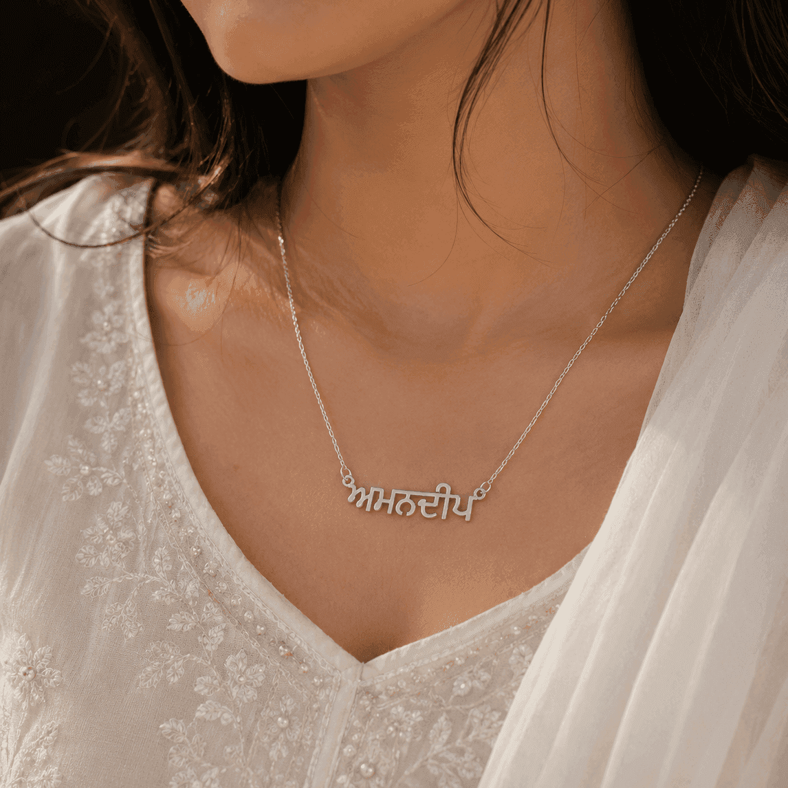 Punjabi Name Necklace in Silver with Intricate Lettering Worn by a Model
