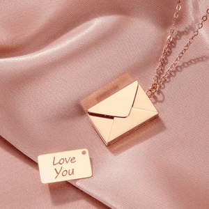 Ankx.in Secret Message Letter Envelope Necklace in rose gold with a small love you note pendant on silky fabric