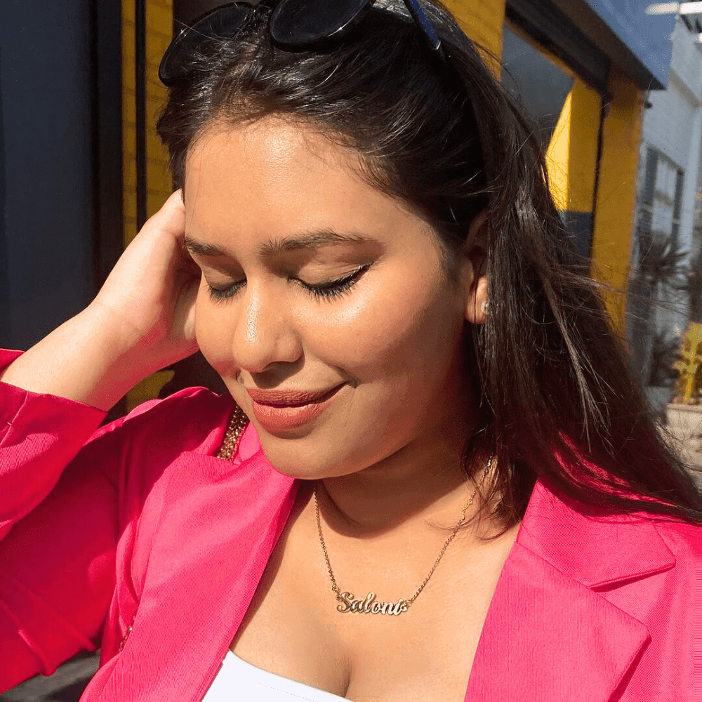 Woman wearing a Simple Name Necklace with the name Sabina in gold tone by Ankx.in