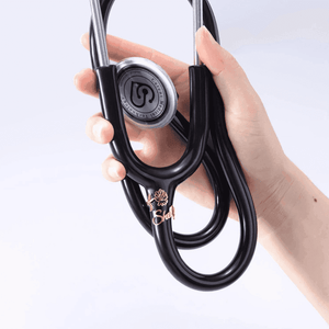 Hand holding a black stethoscope with a personalized stethoscope name tag for medical professionals