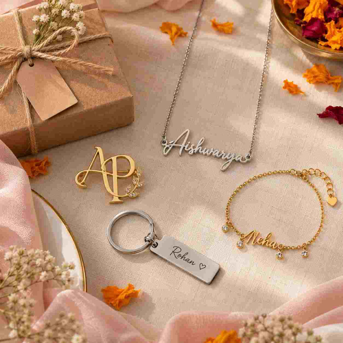 Personalized jewelry gift collection featuring a silver name necklace, gold initial brooch, stainless steel name keychain, and delicate name anklet on beige linen