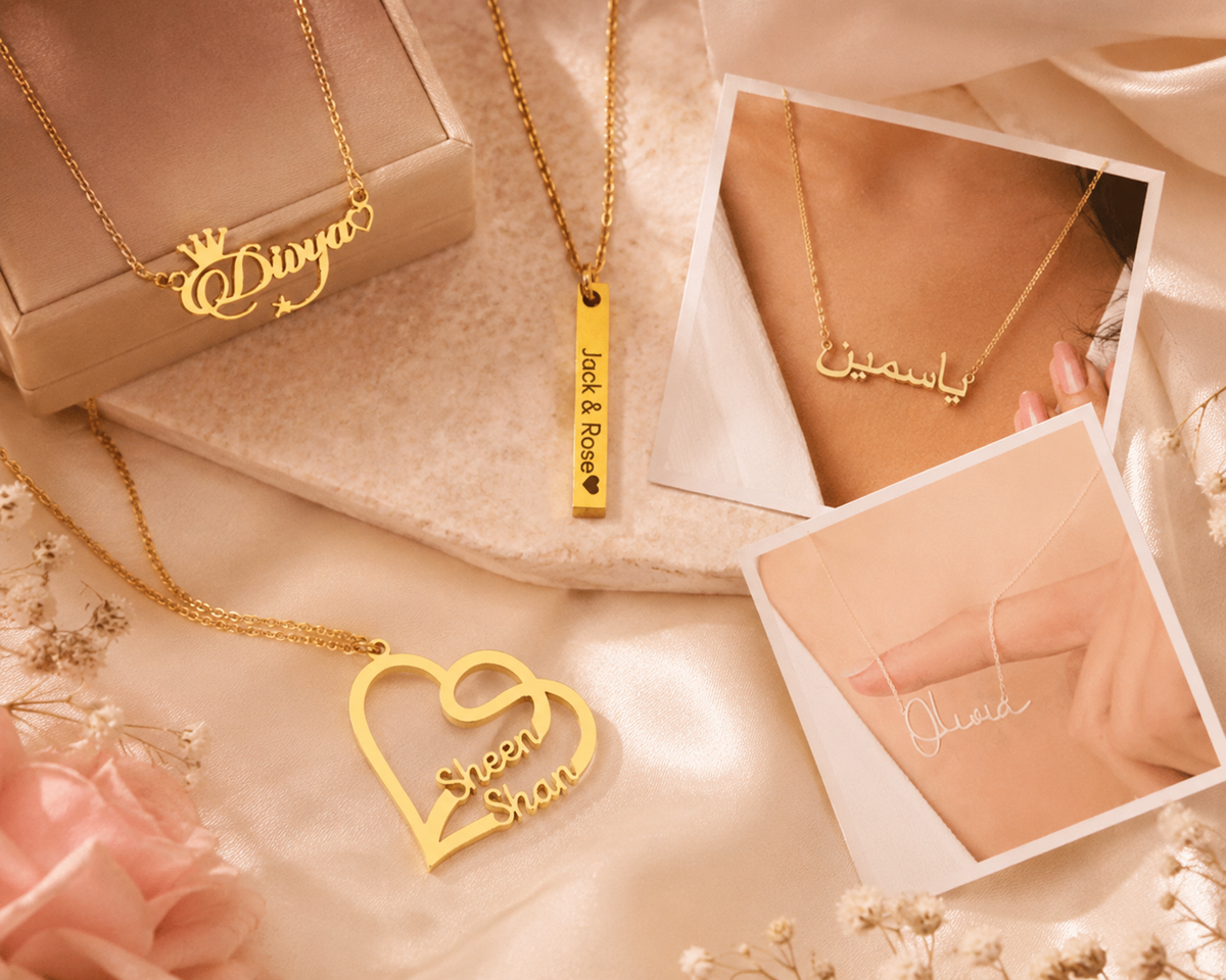 Elegant flat lay featuring personalized name necklaces including crown name necklace, bar necklace, Urdu name necklace, couple heart necklace, and custom gold plated name chain styled together on a warm luxury background.