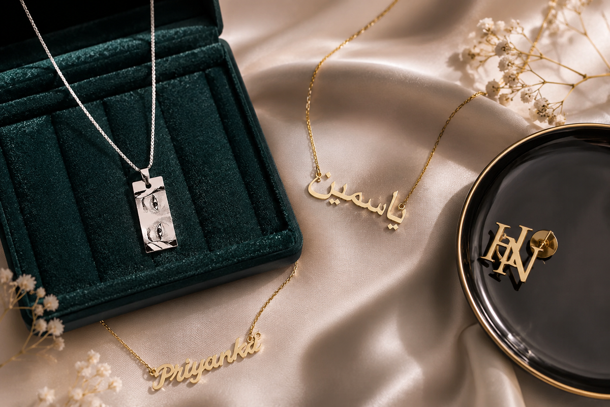 Luxury personalized jewelry collection featuring a custom name necklace, custom Urdu name necklace, personalized photo necklace, and custom initials brooch displayed on elegant satin fabric with premium styling.