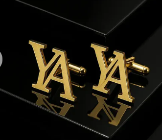 Silver name initial cufflinks engraved with the letter J displayed on a wooden tray