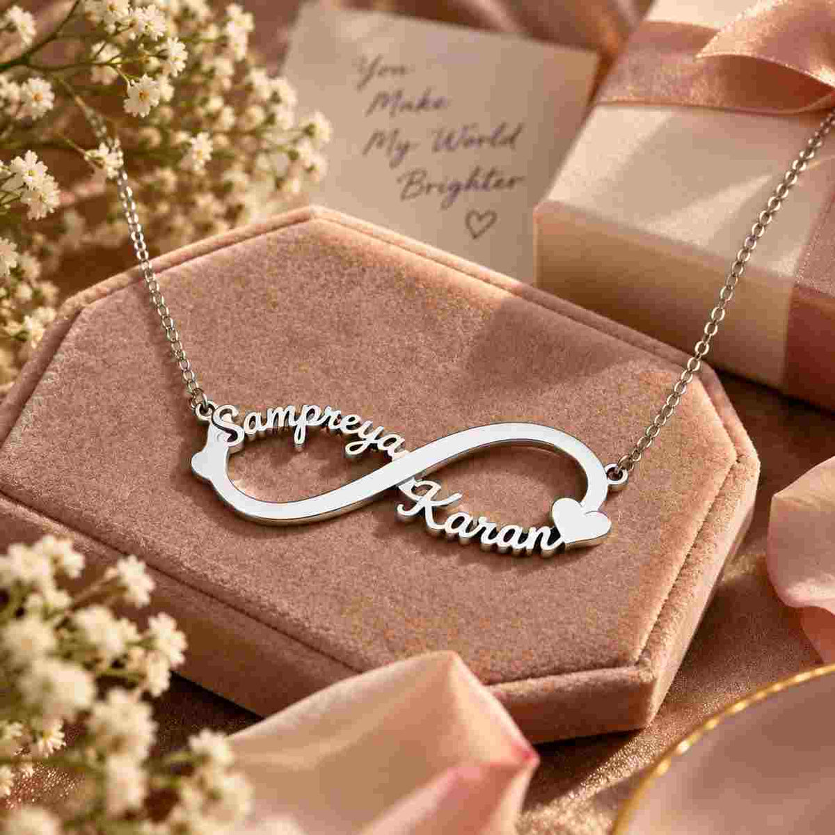 Personalized gold infinity name necklace gift displayed on a luxury velvet jewelry box