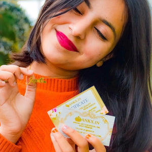 22K gold plated name necklace showcased by a woman with a joyful expression