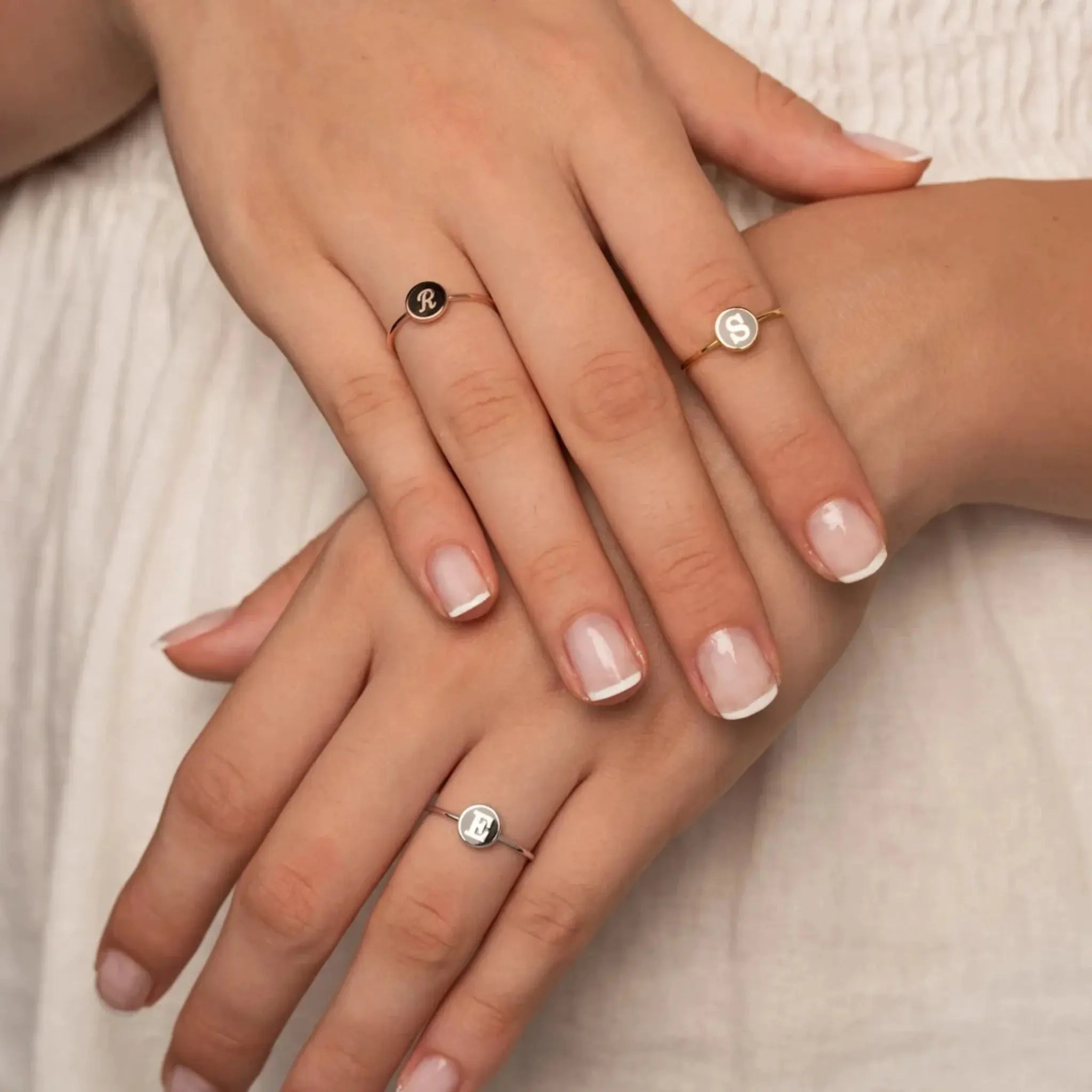 Custom Alphabet Ring with multiple initials worn on hand close-up.