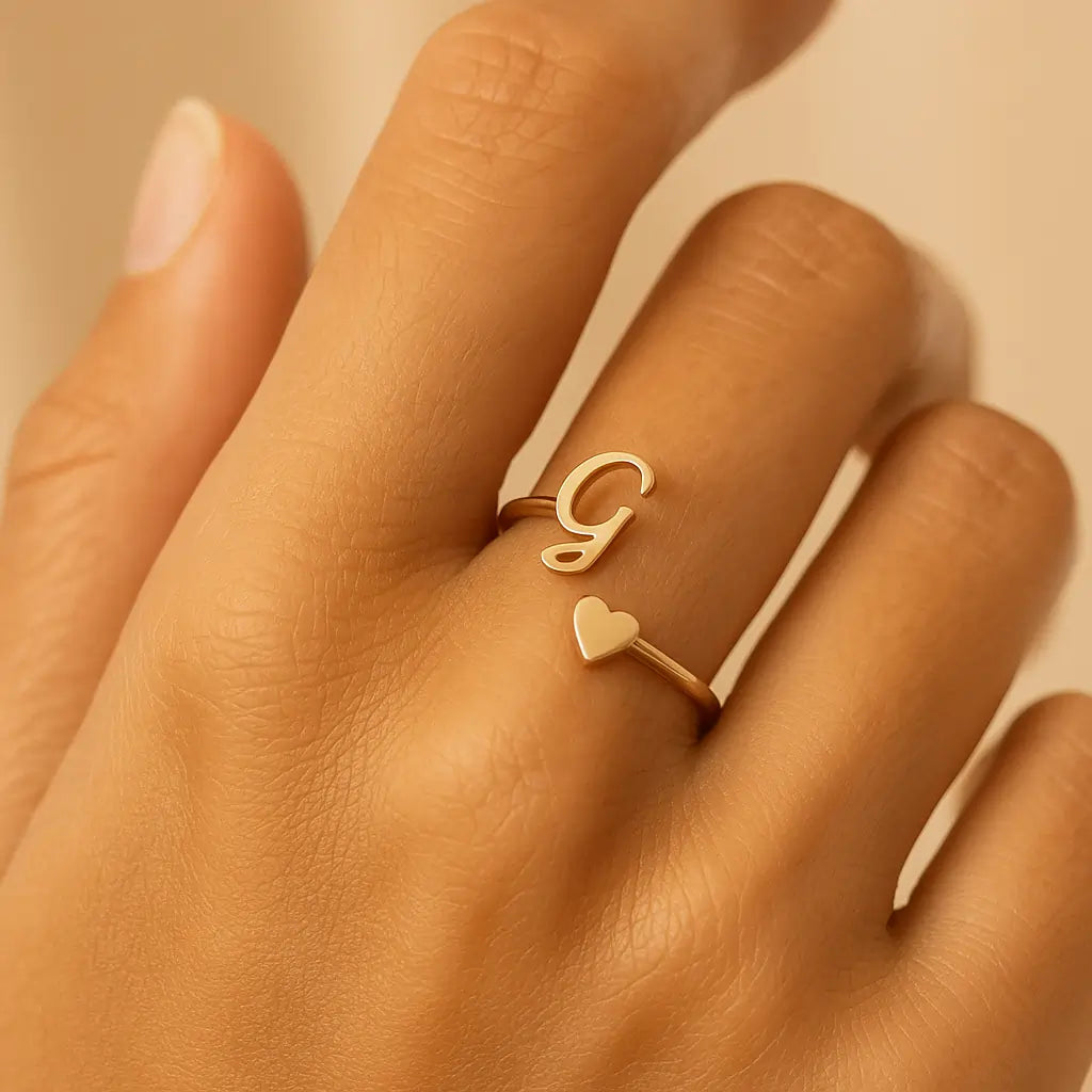 Gold Initial Heart Ring worn on hand close-up.