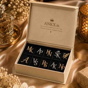 Monogram initial pins displayed in an open ANKX.in branded gift box.