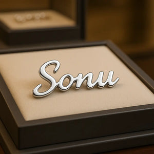 Custom Silver Name Brooch “Sonu” displayed on jewelry shop background – Personalized metal name pin for clothing and gifting.