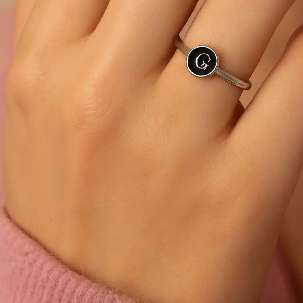Personalized Alphabet Ring letter G close-up on female hand.