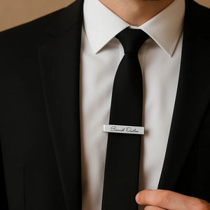 Personalized name tie clip worn with black suit and white shirt