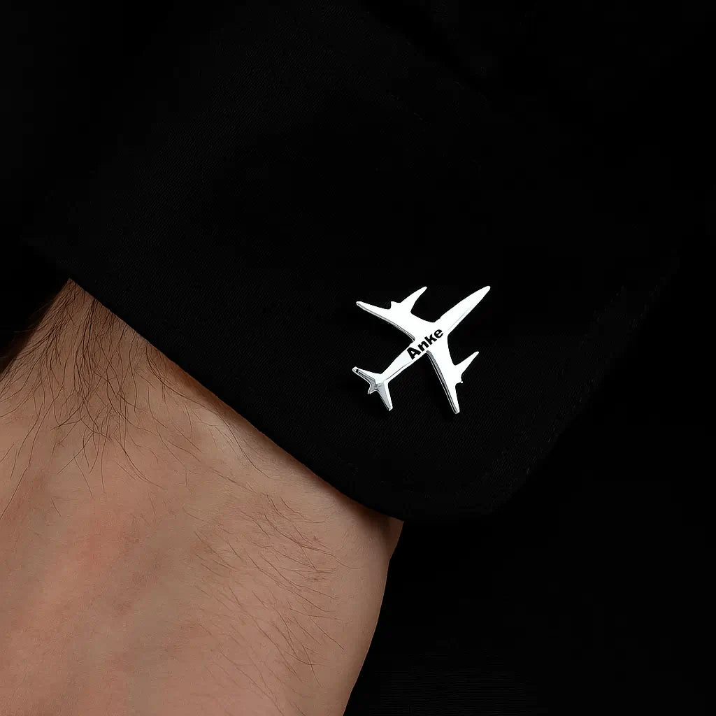 Silver Pilot Cuff Pin with engraved airplane design worn on black cuff.