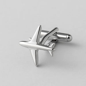 Silver airplane-shaped Pilot Cuff Pin on light background close-up.