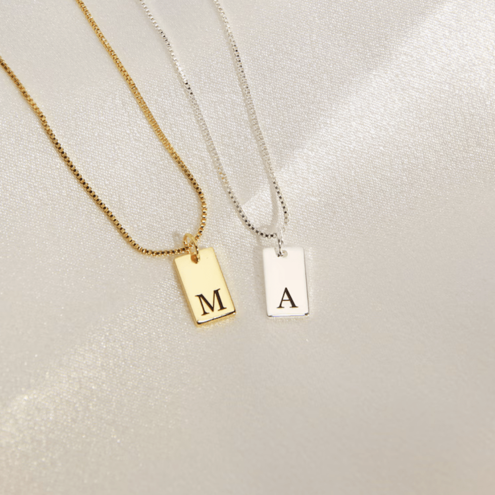 Custom initial letter necklace in gold and silver with engraved letters for personalized style