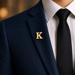 Gold alphabet brooch pin letter K worn on navy blazer lapel for men