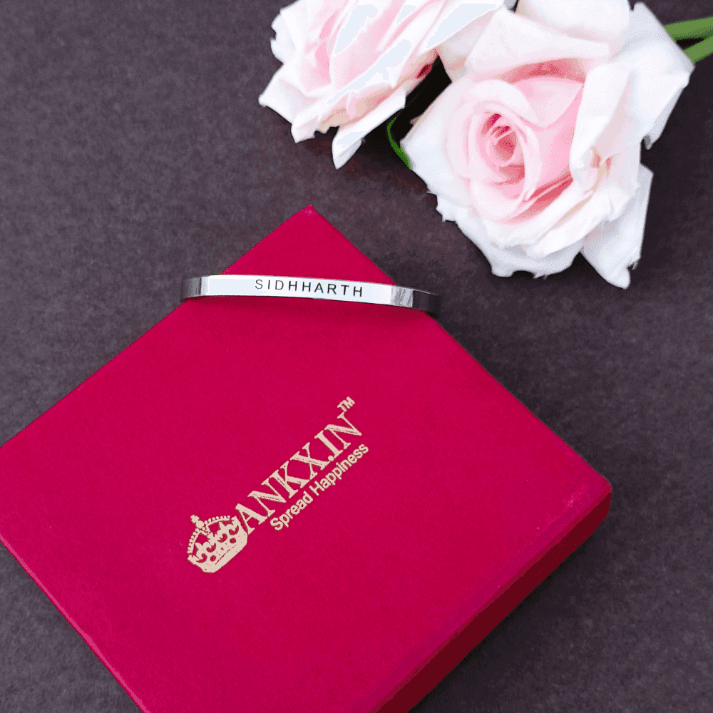 Personalized Silver Name Bracelet engraved with Sidhharth, placed on a premium red ANKX.IN gift box with pink roses.
