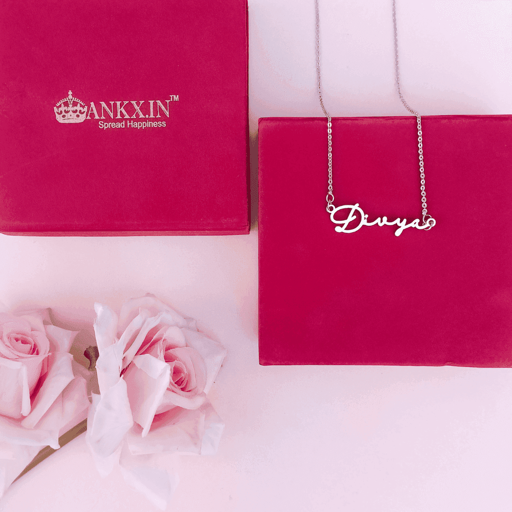 Customized Name Necklace in Silver with the name Divya displayed elegantly on a pink background