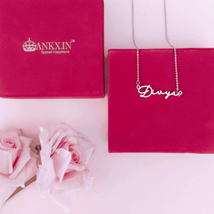 Customized Name Necklace in Silver with the name Divya displayed elegantly on a pink background