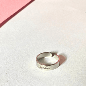 Silver adjustable name ring engraved with Anandhu from Ankx.in on white background