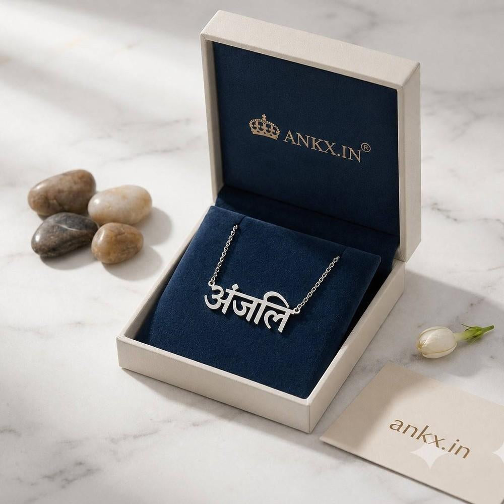 Custom silver Hindi name necklace with Anjali pendant in a premium gift box by Ankx