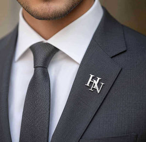Custom Initials Brooch for Men in silver finish personalized lapel pin with HN initials on a formal suit jacket.