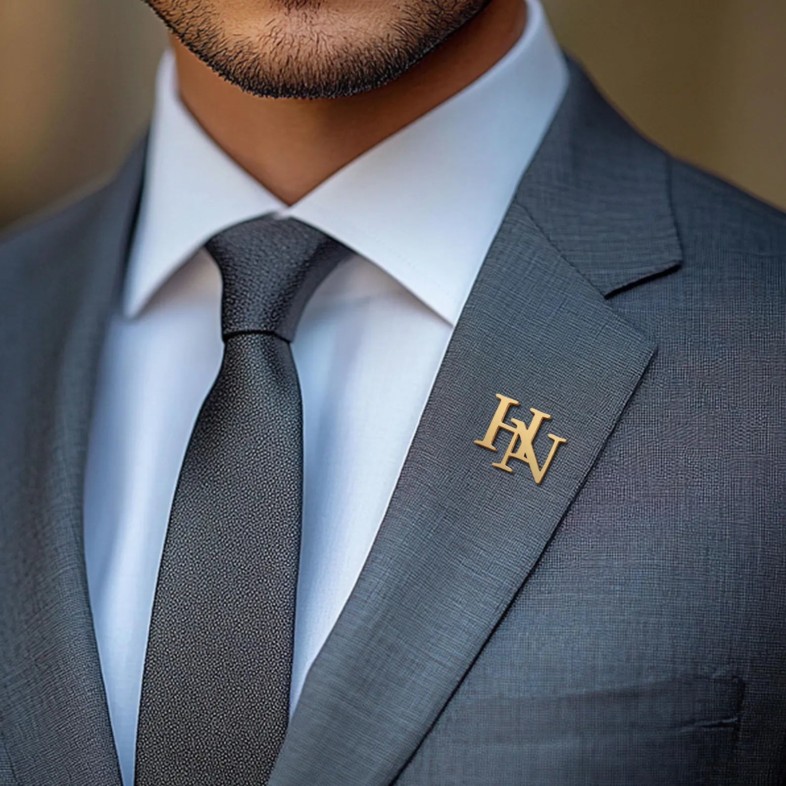 Stylish gold Custom initials Brooch elegantly displayed on a man's suit lapel
